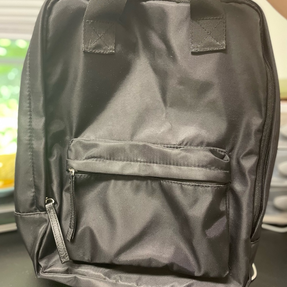 Sleek, black medium size backpack..